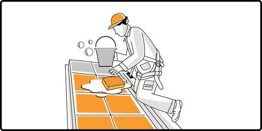 Illustration of a man cleaning solar panels on his roof using a bucket of water and soap, along with a sponge