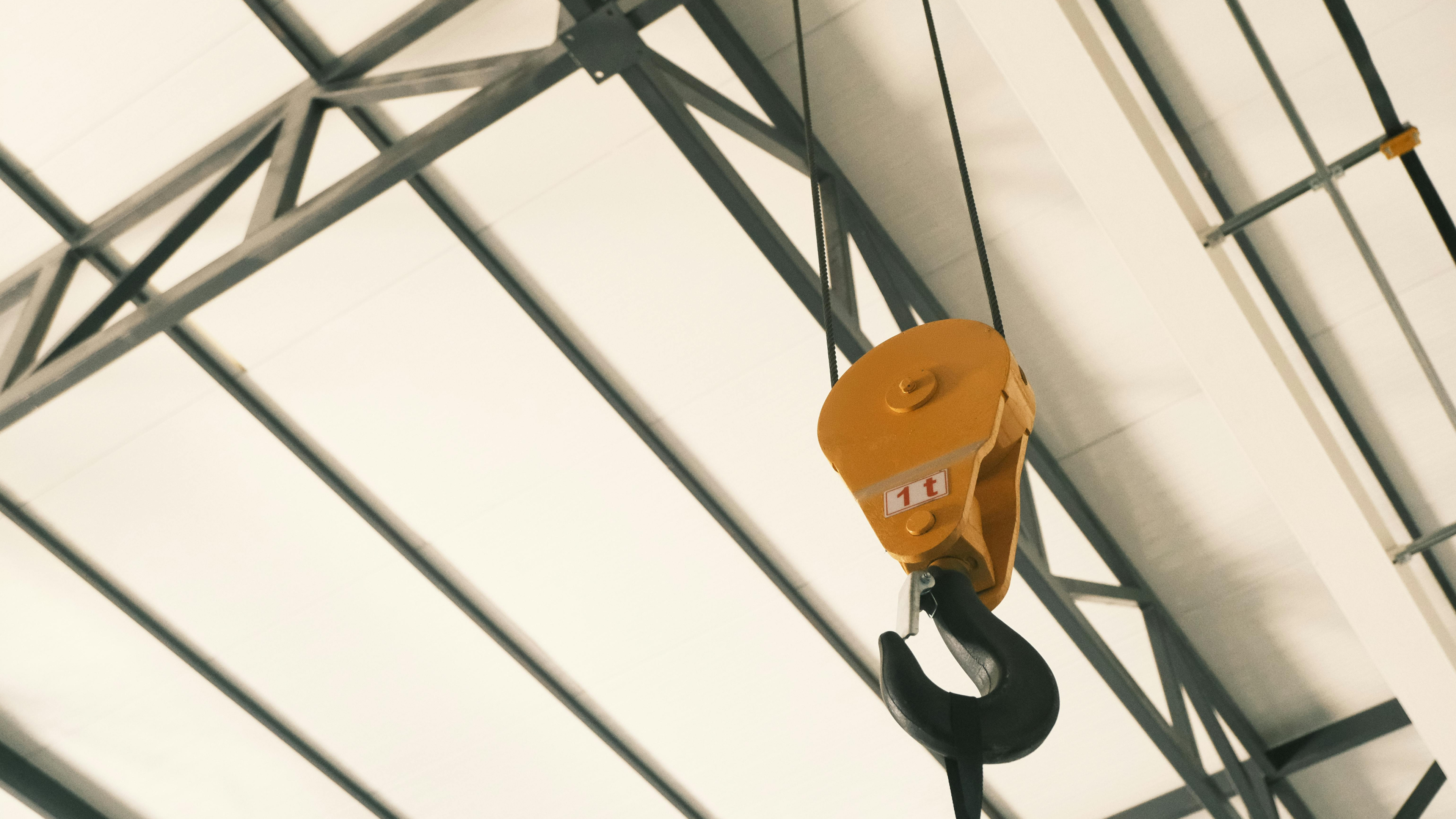 Yellow rope and pulley system with a hook.